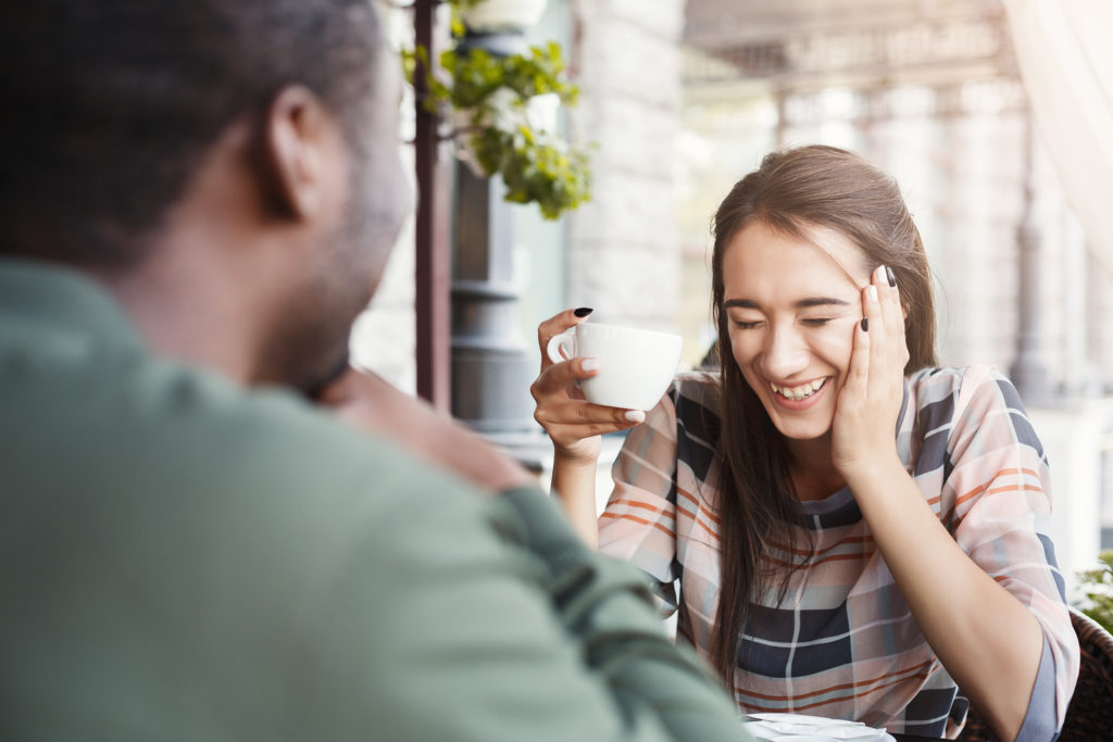 Laughing with a coffee for the first date
