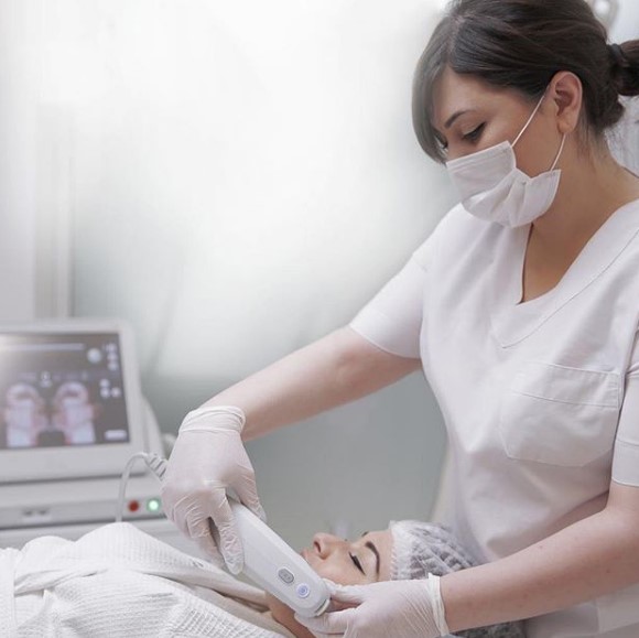 Woman giving Ultherapy treatment