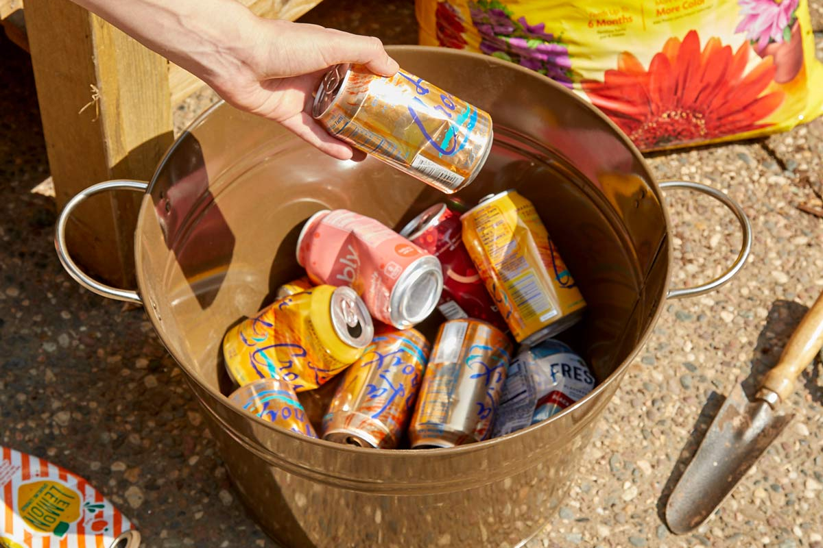 Empty Soda Cans in Bucket 