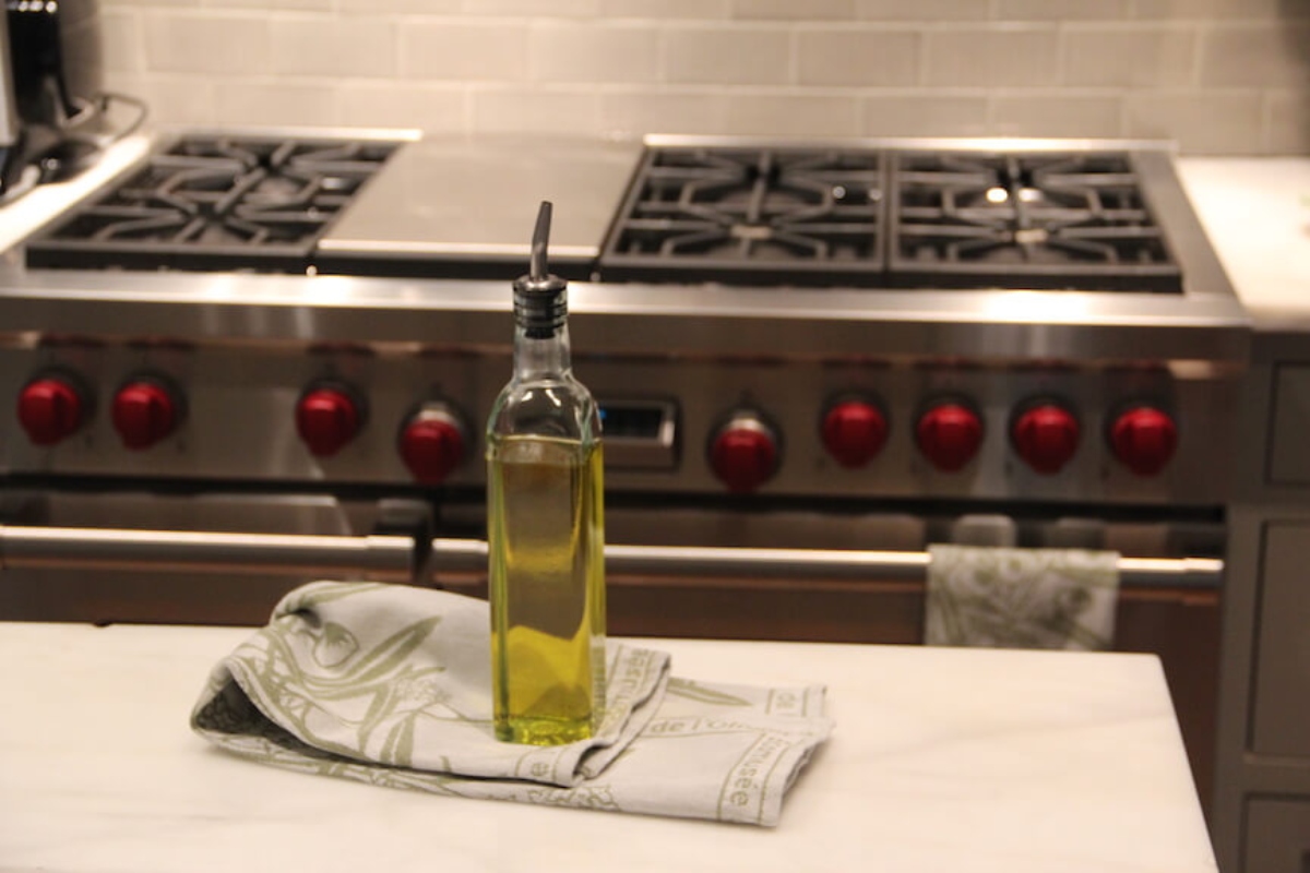 Bottle of Vegetable Oil In Front Of Stainless Steel Stove