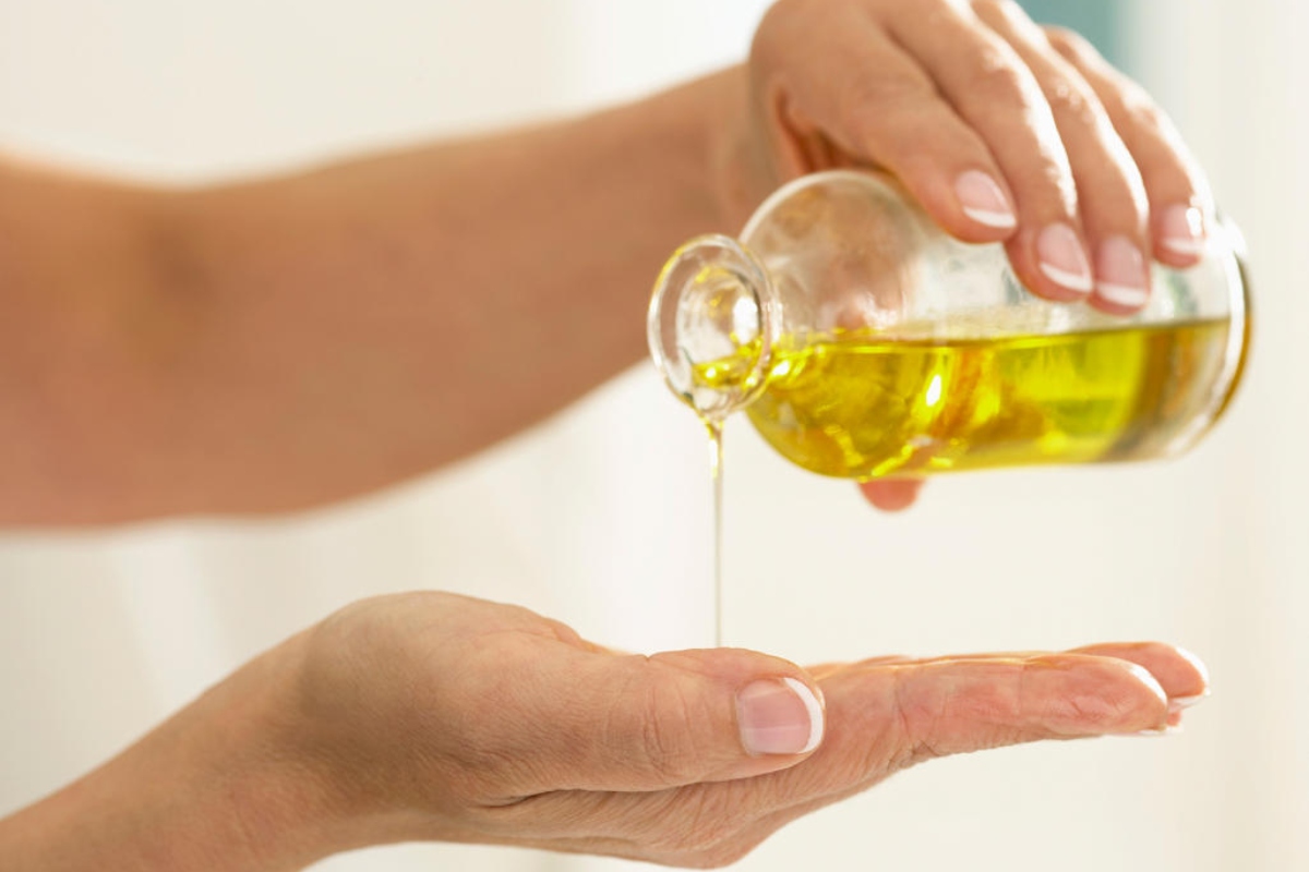 Pouring Vegetable Oil Onto Hands