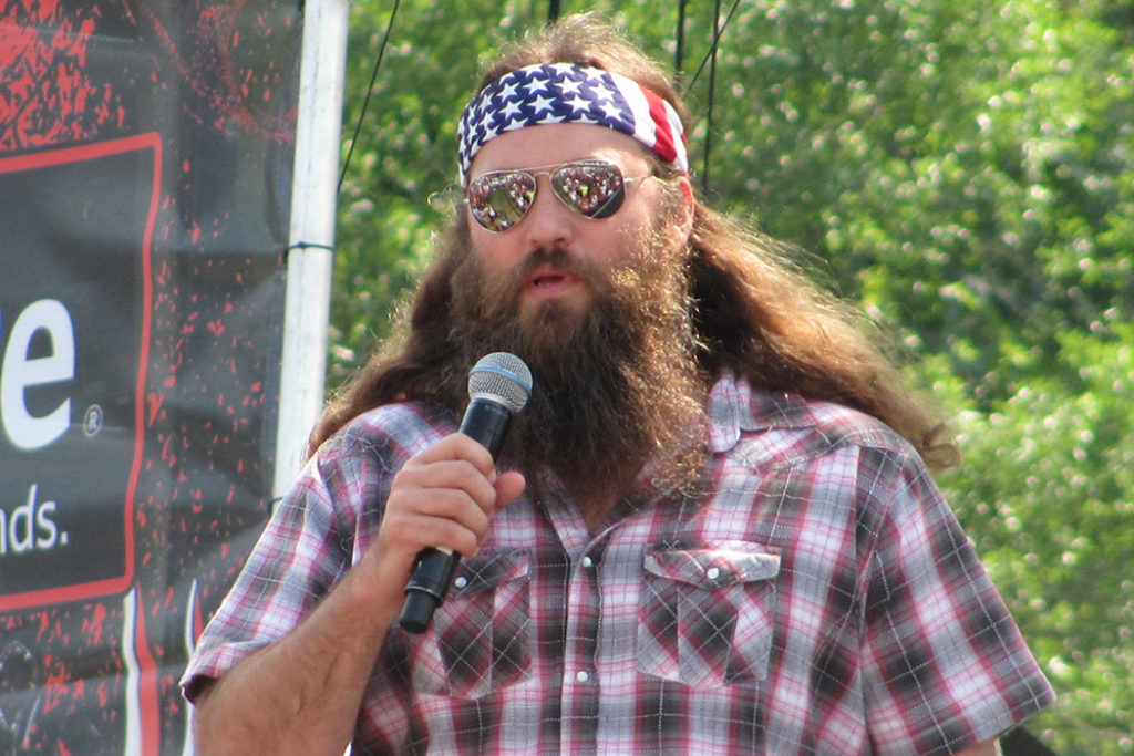 American guy with glasses and a microphone